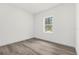 Bright bedroom with large window and wood-look floors at 15123 Sw 61St Court Rd, Ocala, FL 34473