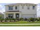 Two-story house with a front porch, two-car garage, and manicured lawn at 2626 Sage Valley Way, Winter Haven, FL 33884