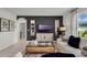 Living room with comfy sofa, coffee table and view into kitchen at 2626 Sage Valley Way, Winter Haven, FL 33884