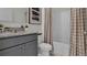 Bathroom with granite vanity, tiled shower and checkered curtains at 2626 Sage Valley Way, Winter Haven, FL 33884