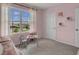 Pink bedroom with a small table and chairs, and a large window at 2626 Sage Valley Way, Winter Haven, FL 33884