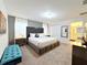 King-size bed, plush bedding, and a teal bench in a spacious bedroom at 3053 Gatsby St, Kissimmee, FL 34746