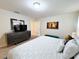 King-size bed, plush bedding, and a teal bench in a spacious bedroom at 3053 Gatsby St, Kissimmee, FL 34746