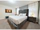 King-size bed, plush bedding, and a teal bench in a spacious bedroom at 3053 Gatsby St, Kissimmee, FL 34746