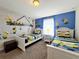 Twin bedroom with Minion-themed bedding and wall mural at 3053 Gatsby St, Kissimmee, FL 34746