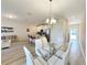 Open concept dining area with a glass table and white chairs at 3053 Gatsby St, Kissimmee, FL 34746