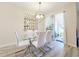 Dining room with glass table, white chairs, and access to a patio at 3053 Gatsby St, Kissimmee, FL 34746