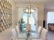 Dining room with glass table and chairs, and a view of the pool at 3053 Gatsby St, Kissimmee, FL 34746
