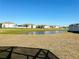 Community features a peaceful lake view with homes surrounding it at 3053 Gatsby St, Kissimmee, FL 34746