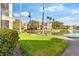 Apartment community walkway alongside a lake with lush landscaping and palm trees at 5117 City St # 724, Orlando, FL 32839