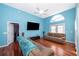 Living Room with hardwood floors, vaulted ceiling, and a large TV at 709 Lake Emerald Ave, Orange City, FL 32763