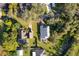Aerial view showing two houses with pools and surrounding landscape at 709 Lake Emerald Ave, Orange City, FL 32763