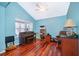 Bright home office features hardwood floors, a piano, and plenty of natural light at 709 Lake Emerald Ave, Orange City, FL 32763