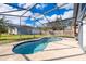 Refreshing kidney-shaped pool with screened enclosure at 709 Lake Emerald Ave, Orange City, FL 32763