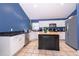 Modern kitchen with white cabinets, granite counters, and island at 709 Lake Emerald Ave, Orange City, FL 32763