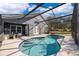 Inviting kidney-shaped pool with screened enclosure and patio furniture at 709 Lake Emerald Ave, Orange City, FL 32763