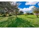 Spacious backyard with lush green grass and mature trees at 709 Lake Emerald Ave, Orange City, FL 32763