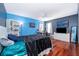 Bedroom with hardwood floors, blue walls, and built in shelving at 709 Lake Emerald Ave, Orange City, FL 32763