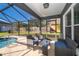 Screened patio area with pool and seating for relaxation at 709 Lake Emerald Ave, Orange City, FL 32763
