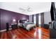 Main bedroom with hardwood floors, neutral decor, and plenty of natural light at 709 Lake Emerald Ave, Orange City, FL 32763