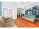 Open living room and Gathering room with hardwood floors and vaulted ceilings at 709 Lake Emerald Ave, Orange City, FL 32763