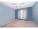 Cozy bedroom with neutral carpeting and large window at 709 Lake Emerald Ave, Orange City, FL 32763