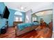 Spacious living room with hardwood floors, vaulted ceiling, and a large TV at 709 Lake Emerald Ave, Orange City, FL 32763