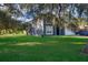 Gray house with white garage and covered boat at 709 Lake Emerald Ave, Orange City, FL 32763