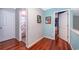Hardwood floor hallway with access to bedrooms and bathroom at 709 Lake Emerald Ave, Orange City, FL 32763