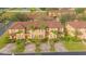 Aerial view of townhouses with brown roofs and palm trees at 121 Palermo St, Davenport, FL 33897