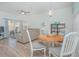Dining area with round wooden table and white chairs, near living room at 121 Palermo St, Davenport, FL 33897