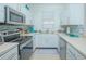 Bright kitchen featuring stainless steel appliances and white cabinetry at 121 Palermo St, Davenport, FL 33897
