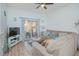 Living room with comfy sectional sofa, sliding door to patio, and wood floors at 121 Palermo St, Davenport, FL 33897