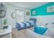 Bright bedroom with a twin bed, couch, and teal accent wall at 121 Palermo St, Davenport, FL 33897