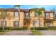 Two story tan home with brown roof and landscaping at 121 Palermo St, Davenport, FL 33897