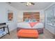 Spacious main bedroom featuring a wood accent wall and an orange bench at 121 Palermo St, Davenport, FL 33897