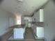 Modern kitchen with white cabinets and an island at 1360 Lumpini St, St Cloud, FL 34771