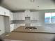 New kitchen with white cabinets and quartz countertops at 1360 Lumpini St, St Cloud, FL 34771