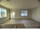 Bright living room with two windows and door to patio at 1360 Lumpini St, St Cloud, FL 34771