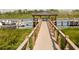 Wooden dock with gazebo and small boats at 14501 Grove Resort Ave # 2122, Winter Garden, FL 34787