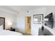 Bright bedroom with ensuite bathroom access and a wall-mounted TV at 14501 Grove Resort Ave # 2122, Winter Garden, FL 34787
