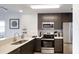 Modern kitchen with stainless steel appliances and white countertops at 14501 Grove Resort Ave # 2122, Winter Garden, FL 34787