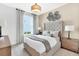Spacious bedroom with upholstered bed and window with curtains at 2322 Lily Bloom Rd, St Cloud, FL 34771