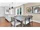 Kitchen dining area with a long wooden table and white chairs at 2322 Lily Bloom Rd, St Cloud, FL 34771