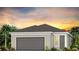 Single-story home with gray garage door and neutral exterior at 2322 Lily Bloom Rd, St Cloud, FL 34771