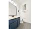 Clean bathroom with dark blue vanity and gray flooring at 2387 Laurel Blossom Cir, Ocoee, FL 34761