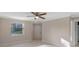 Spacious bedroom with ceiling fan and large window at 3012 Parkway Blvd # 102, Kissimmee, FL 34747