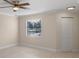 Bright bedroom with ceiling fan and window with blinds at 3012 Parkway Blvd # 102, Kissimmee, FL 34747