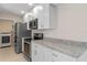 Modern kitchen with white cabinets and granite countertops at 3012 Parkway Blvd # 102, Kissimmee, FL 34747