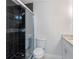 Bathroom with black tile shower and updated toilet at 3012 Parkway Blvd # 102, Kissimmee, FL 34747